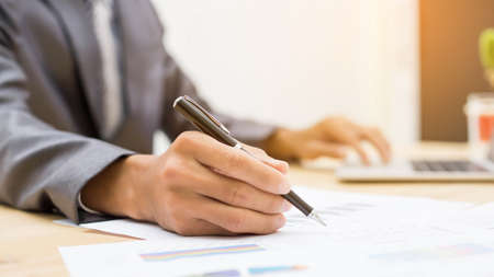 Business team working on laptop, while sitting at office. Business people. の写真素材