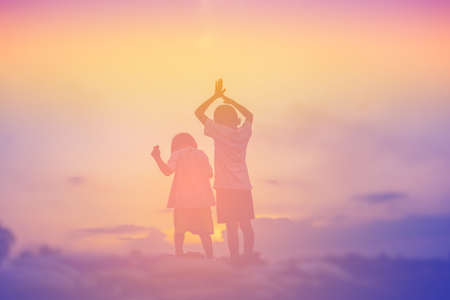 silhouette of a happy children and happy time sunsetの写真素材
