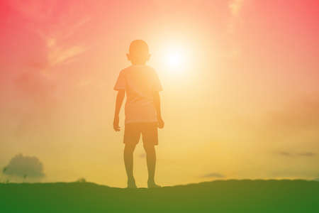 kid silhouette,Moments of the child's joy. On the Nature sunsetの写真素材