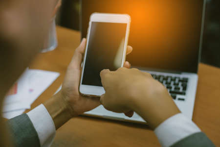 Closeup of hand using smartphone with effectsの写真素材