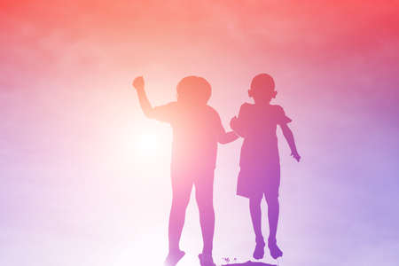 silhouette of a happy children and happy time sunset