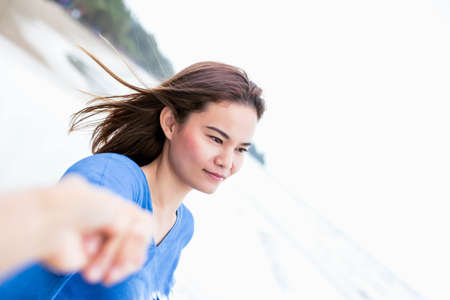 Asian men and women shake hands on the beach