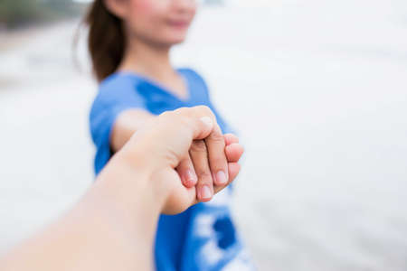 Asian men and women shake hands on the beachの写真素材