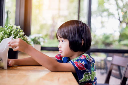 Portrait of little girl eating cookies in the kitchenの写真素材