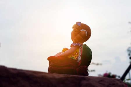 Portrait of sad child sitting outdoors.