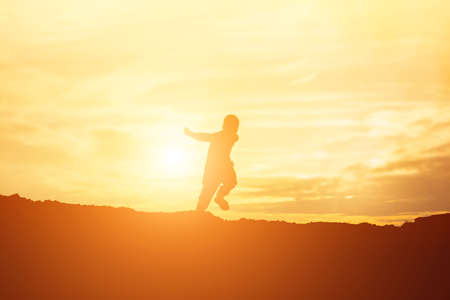 kid silhouette,Moments of the child's joy. On the Nature sunset