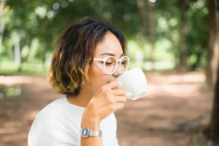 Woman enjoying fresh cooffee stock photoの写真素材