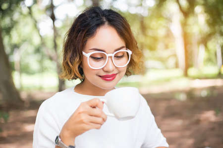 Woman enjoying fresh cooffee stock photoの写真素材