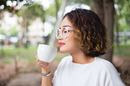 Woman enjoying fresh cooffee stock photoの写真素材