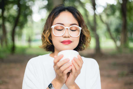 Woman enjoying fresh cooffee stock photoの写真素材