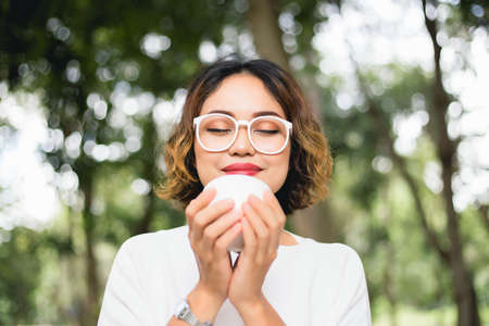 Woman enjoying fresh cooffee stock photoの写真素材