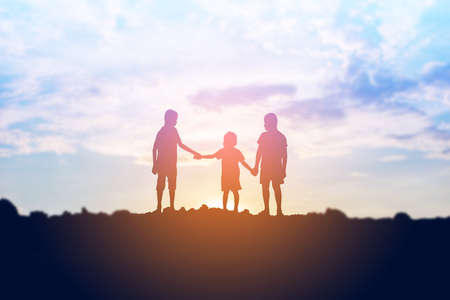 silhouette of a happy children and happy time sunsetの写真素材