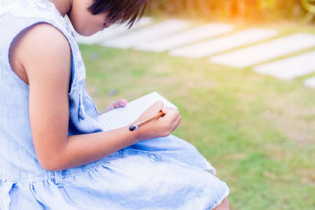 Happy cute child girl on the blur green background.の写真素材
