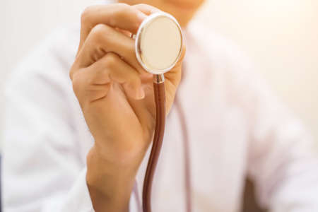Young doctor working in his office stock photoの写真素材