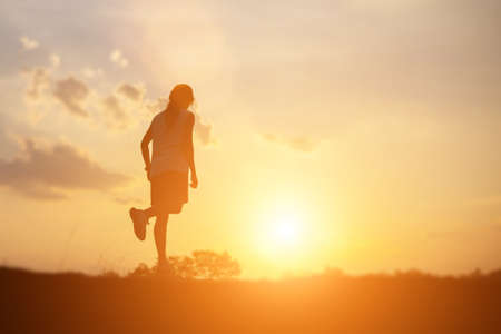 strong confidence woman open arms under the sunset. の写真素材