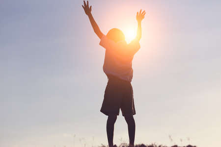 kid silhouette,Moments of the child's joy. On the Nature sunsetの写真素材