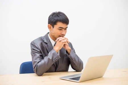 Cheerful businessman taking notes while working in the office.