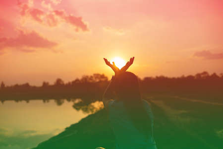 strong confidence woman open arms under the sunset.の写真素材