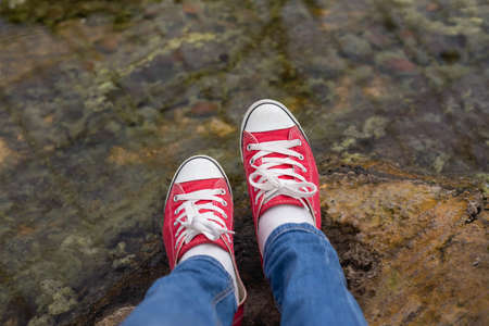 Red Sneakers Shoes Walking On Dirty Concrete Top View , Canvas Shoes Walking On Concrete Great For Any Use.の写真素材