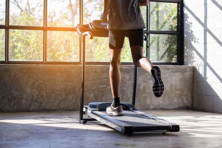 Young men exercise on an automatic treadmill