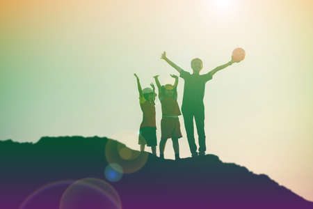 silhouette of a happy children and happy time sunsetの写真素材