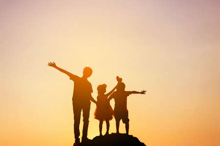 silhouette of a happy children and happy time sunsetの写真素材