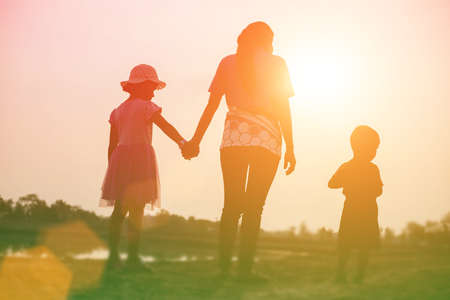 silhouette of a happy family and happy time sunsetの写真素材