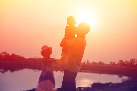 silhouette of a happy family and happy time sunsetの写真素材