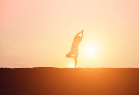 Young woman raise hands up for her success, Concept of Success in life.の写真素材