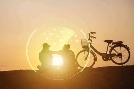 silhouette of couple driving bike happy time sunsetの写真素材