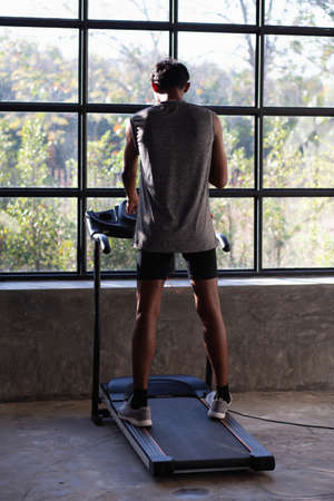 Young men exercise on an automatic treadmill