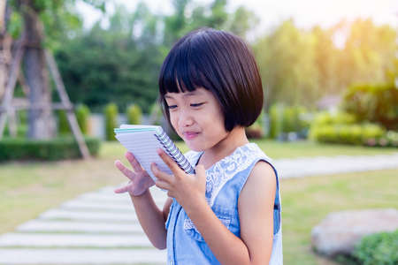 Happy cute child girl on the blur green background.の写真素材