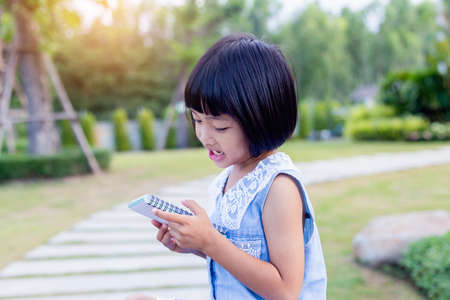 Happy cute child girl on the blur green background.の写真素材