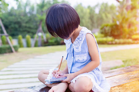 Happy cute child girl on the blur green background.の写真素材