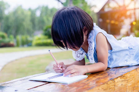 Happy cute child girl on the blur green background.の写真素材