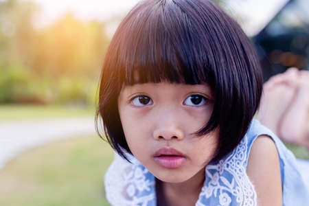 Happy cute child girl on the blur green background.の写真素材