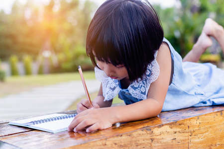 Happy cute child girl on the blur green background.の写真素材