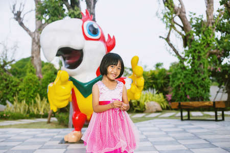 Happy cute child girl on the blur green background.の写真素材