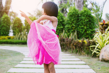 Happy cute child girl on the blur green background.の写真素材