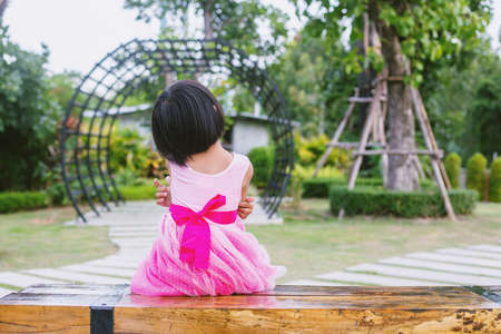 Happy cute child girl on the blur green background.の写真素材