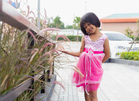 Happy cute child girl on the blur green background.の写真素材