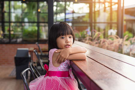 Happy cute child girl on the blur green background.の写真素材
