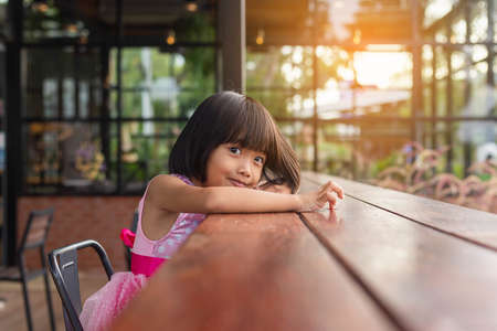 Happy cute child girl on the blur green background.の写真素材