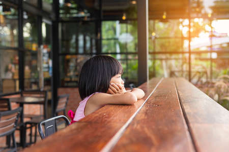 Happy cute child girl on the blur green background.の写真素材