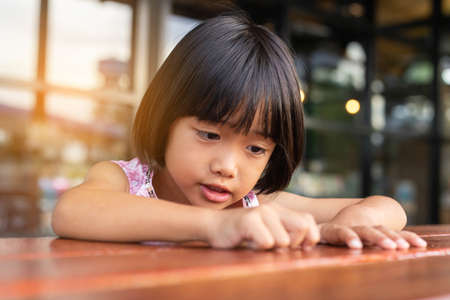 Happy cute child girl on the blur green background.の写真素材