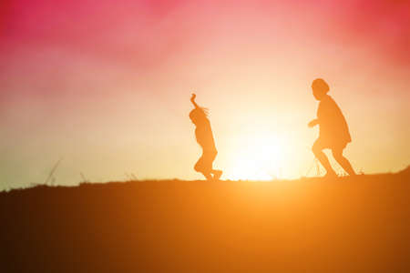 kid silhouette,Moments of the child's joy. On the Nature sunsetの写真素材
