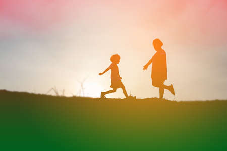 kid silhouette,Moments of the child's joy. On the Nature sunsetの写真素材