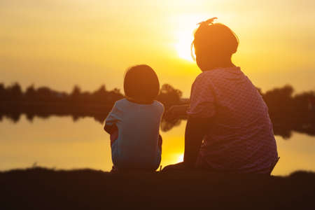 kid silhouette,Moments of the child's joy. On the Nature sunsetの写真素材