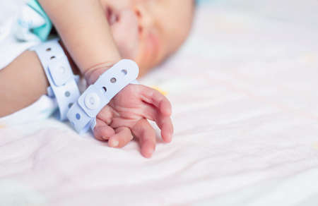Small delicate little hand of newborn - close portraitの写真素材
