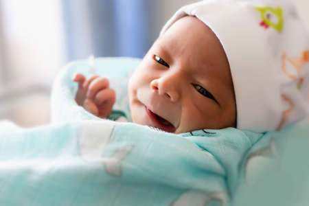 newborn baby looking at the cameraの写真素材
